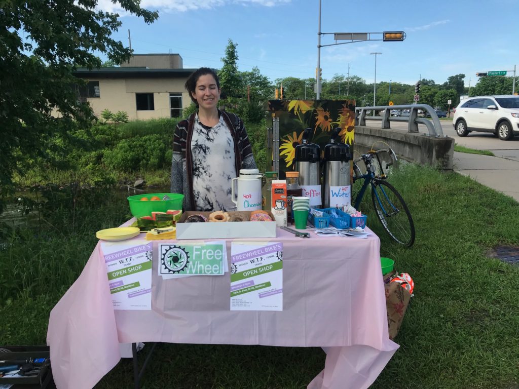 A Freewheel volunteer at a bike path station, giving out tasty food and drink, and information about what our organization has to offer :)